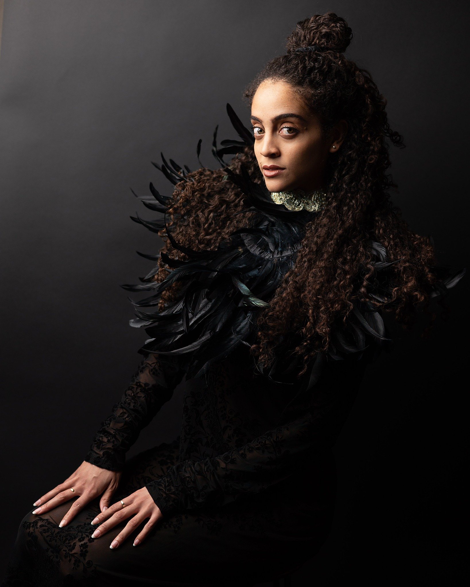 Woman in a black lace and feathered dress