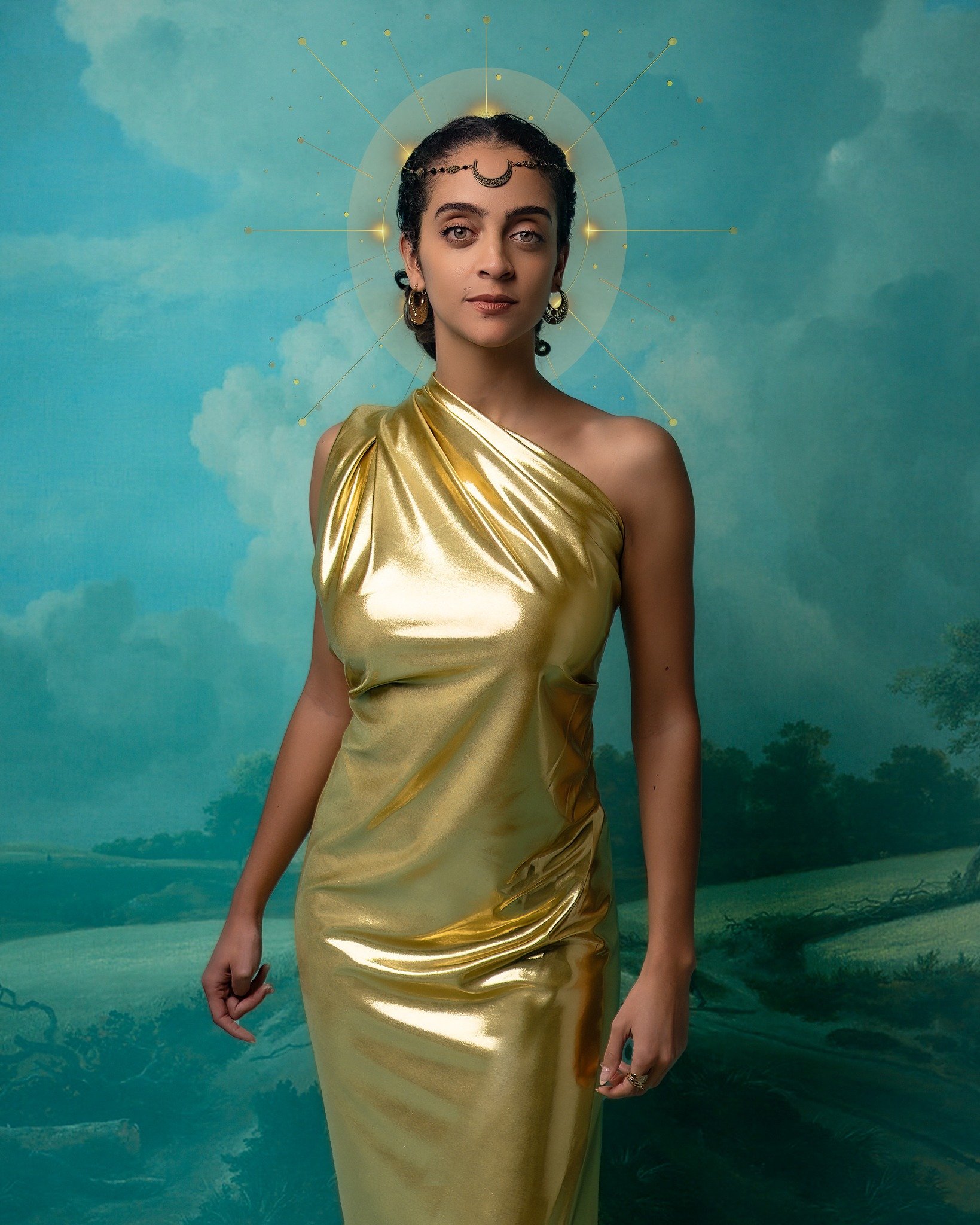 Woman in a gold gown with a moon-shaped headpiece