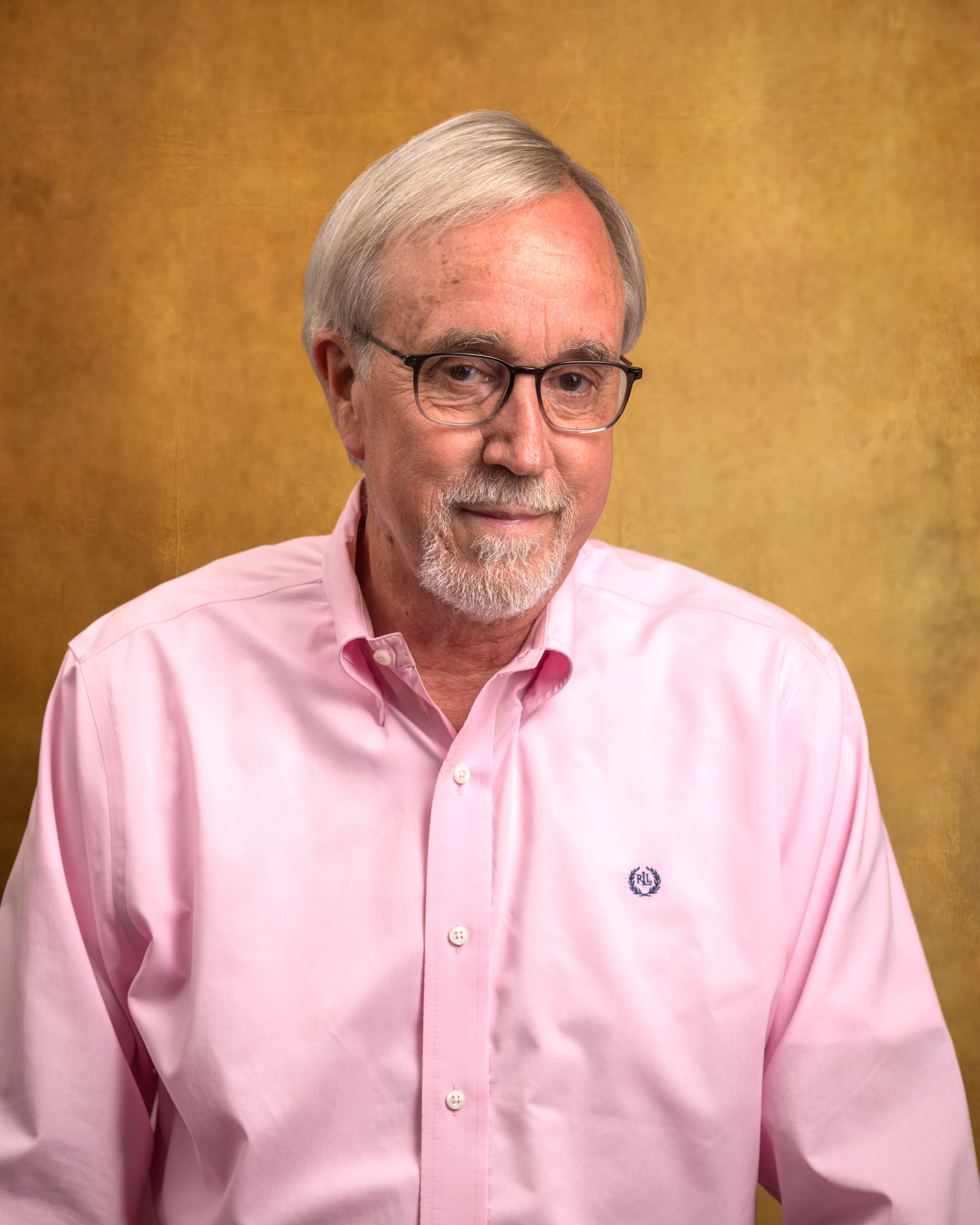 Man with graying hair, goatee, and glasses