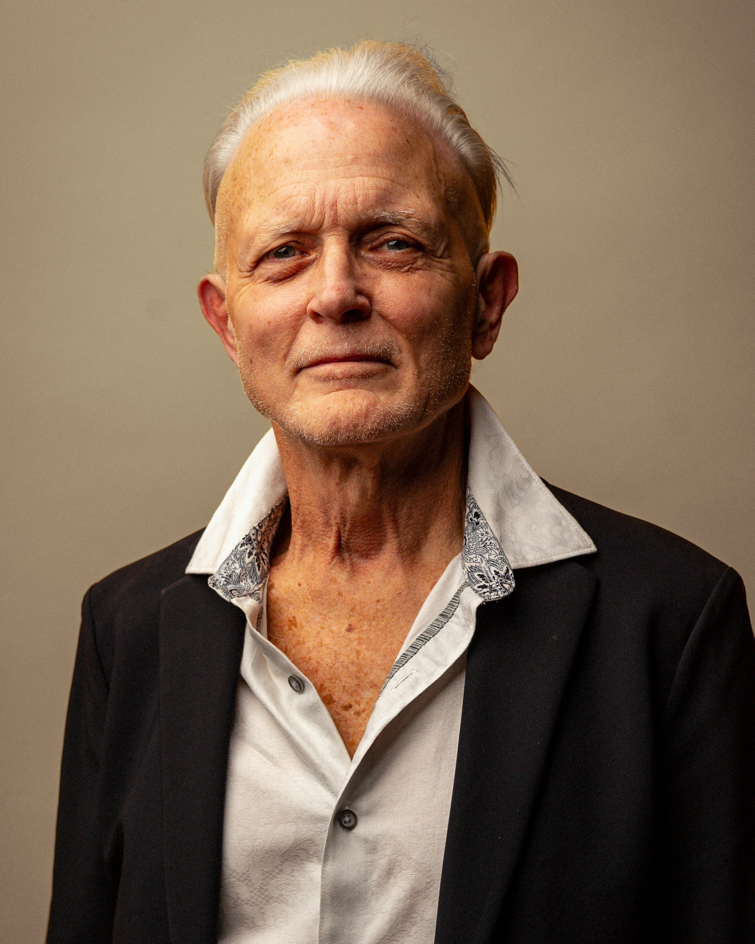 Portrait of Dave in a dark suit jacket