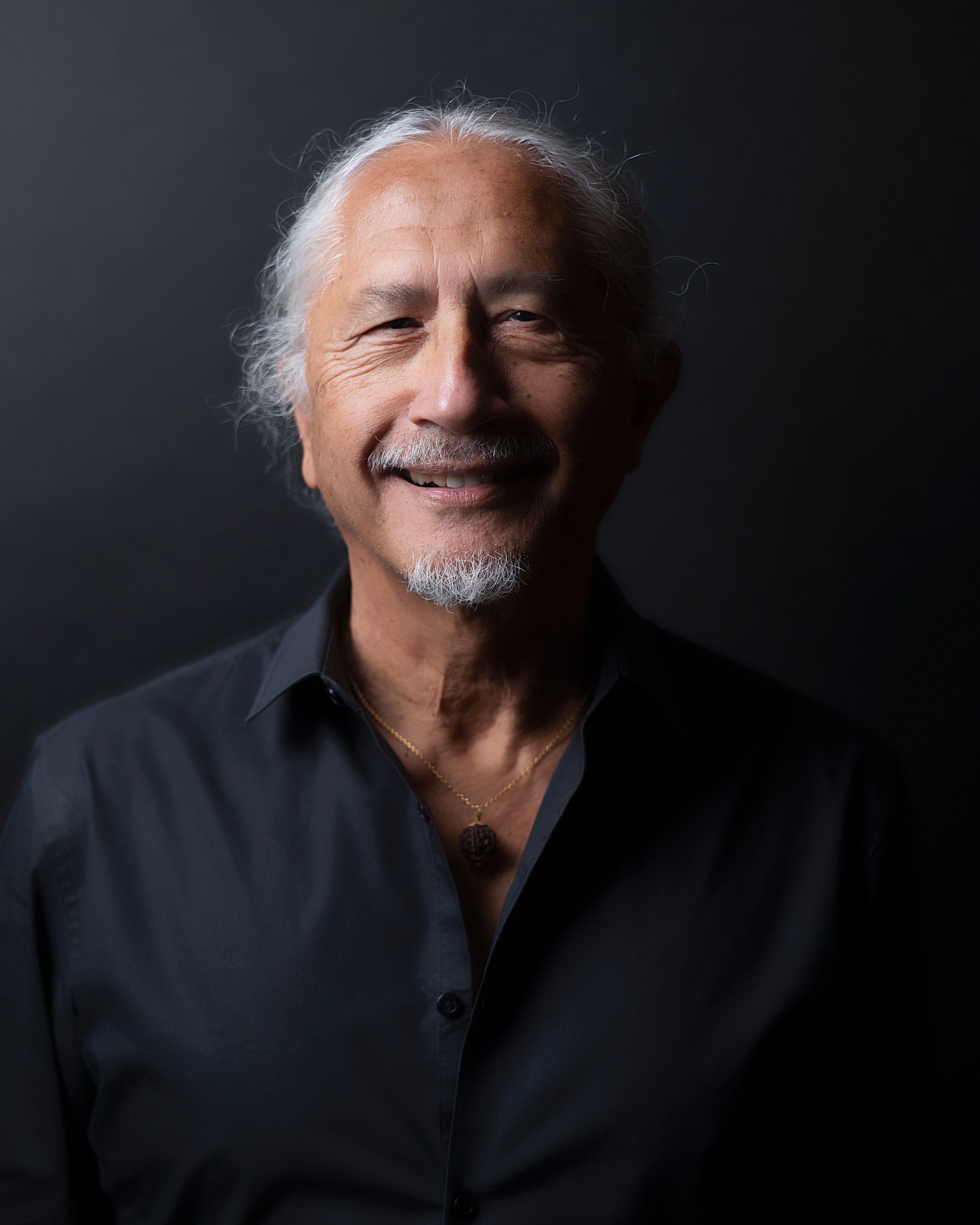 Portrait of Frank with silver hair and a goatee