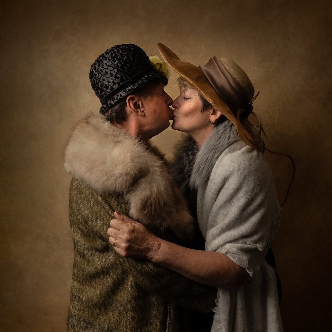 Man and woman in vintage winter clothing sharing a kiss in profile