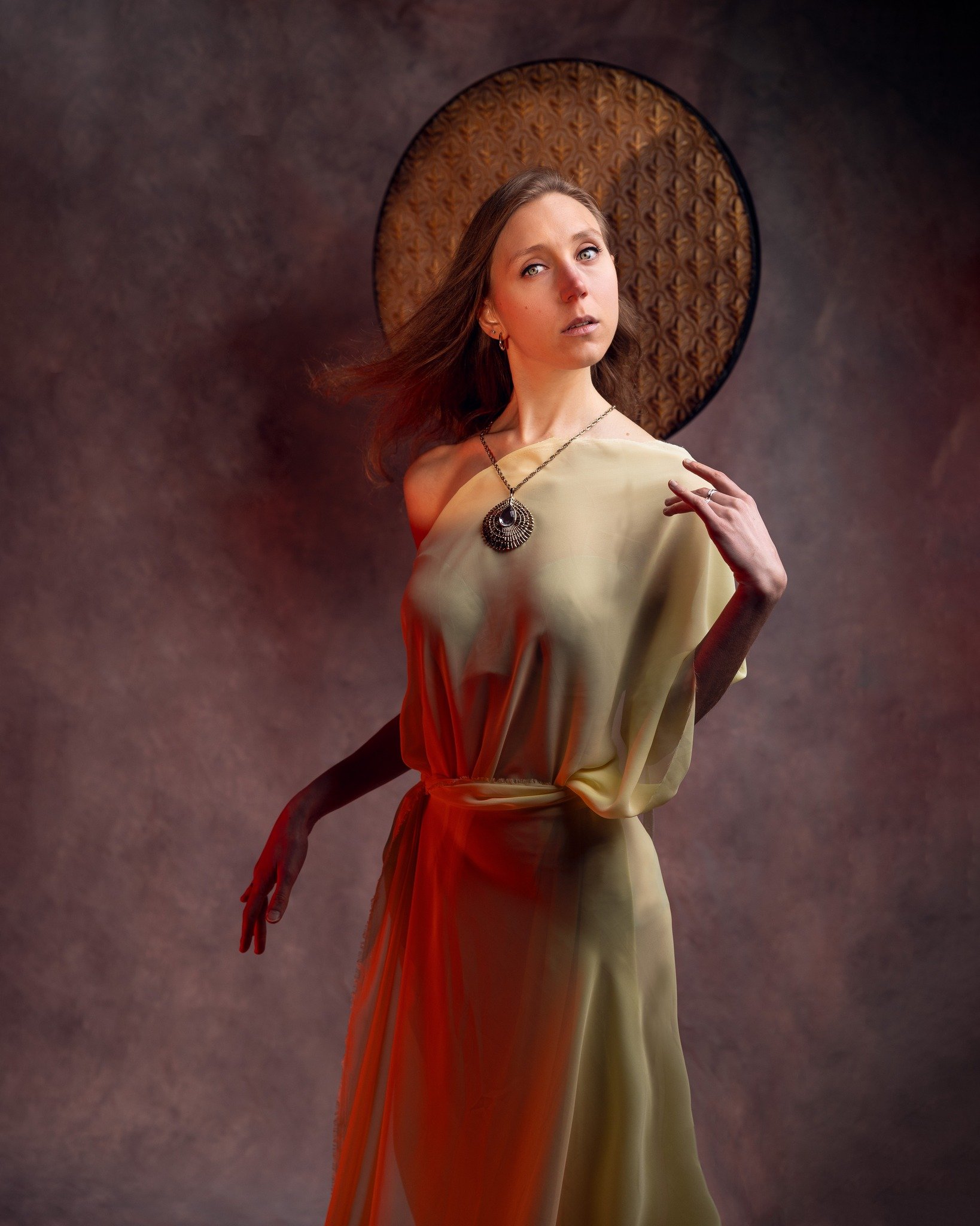 Woman in a green satin dress and large necklace