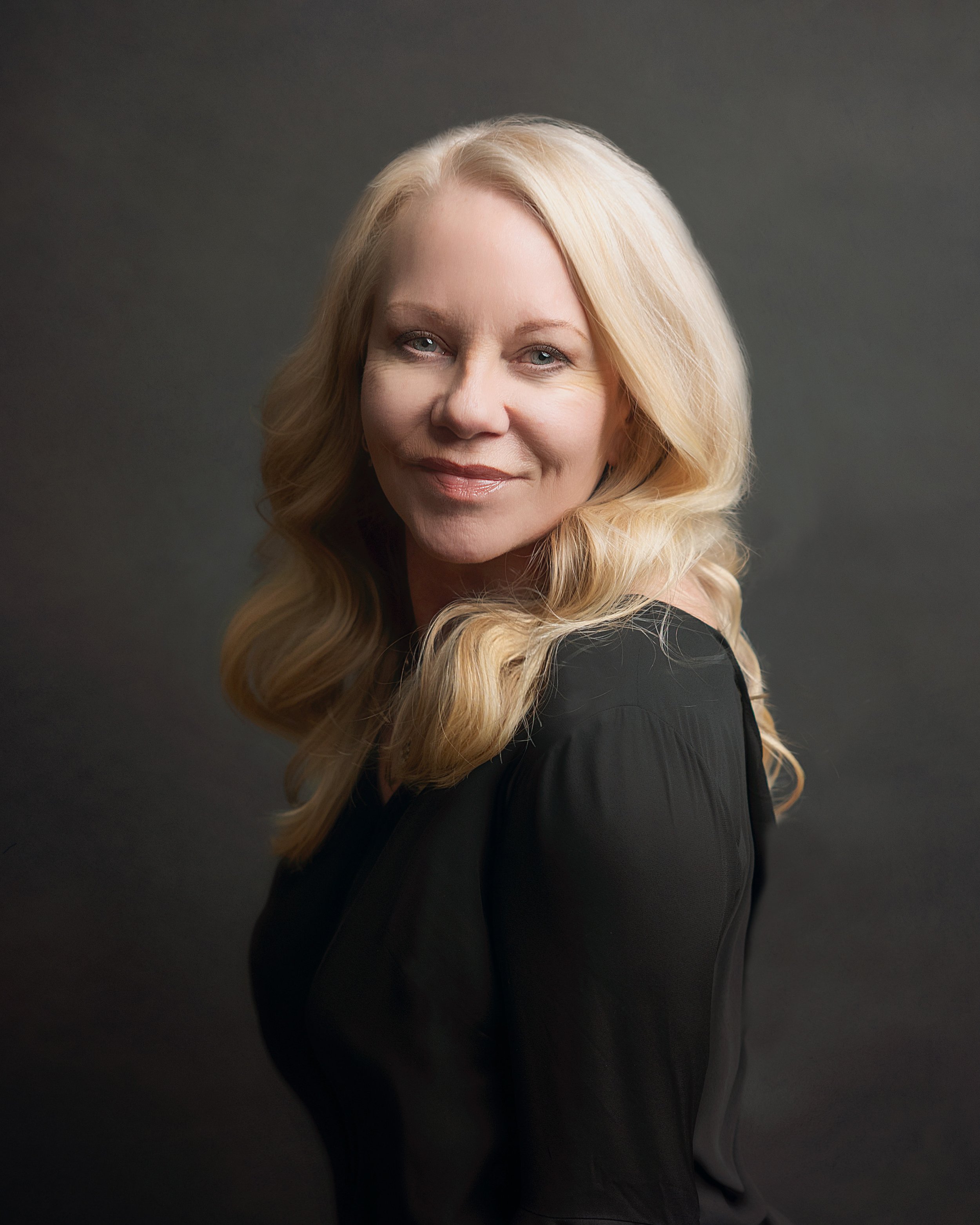 Portrait of Tricia in a dark, moody studio setting